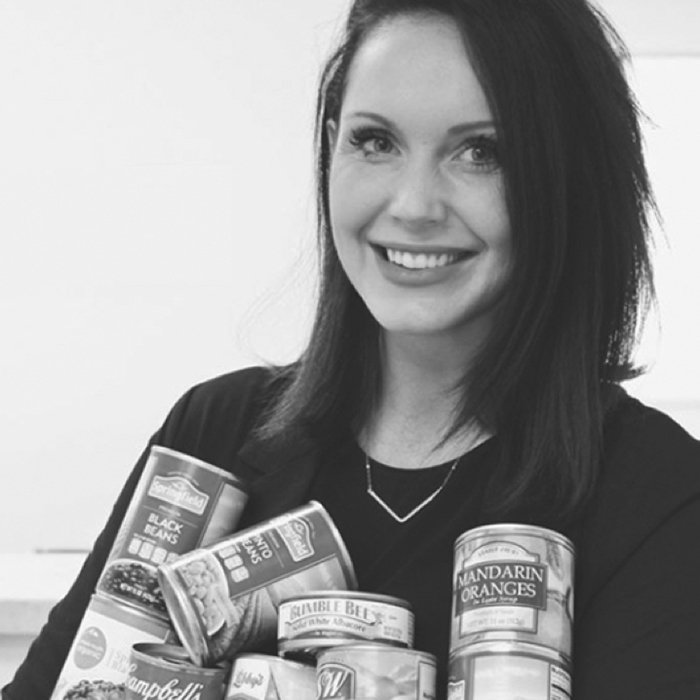 Woman with arms full of canned food