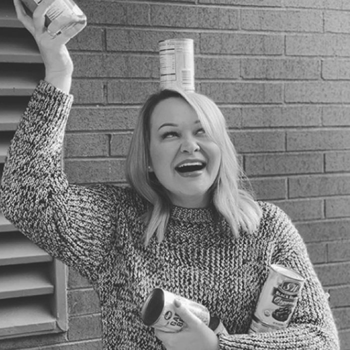 Woman with canned food waving in the air